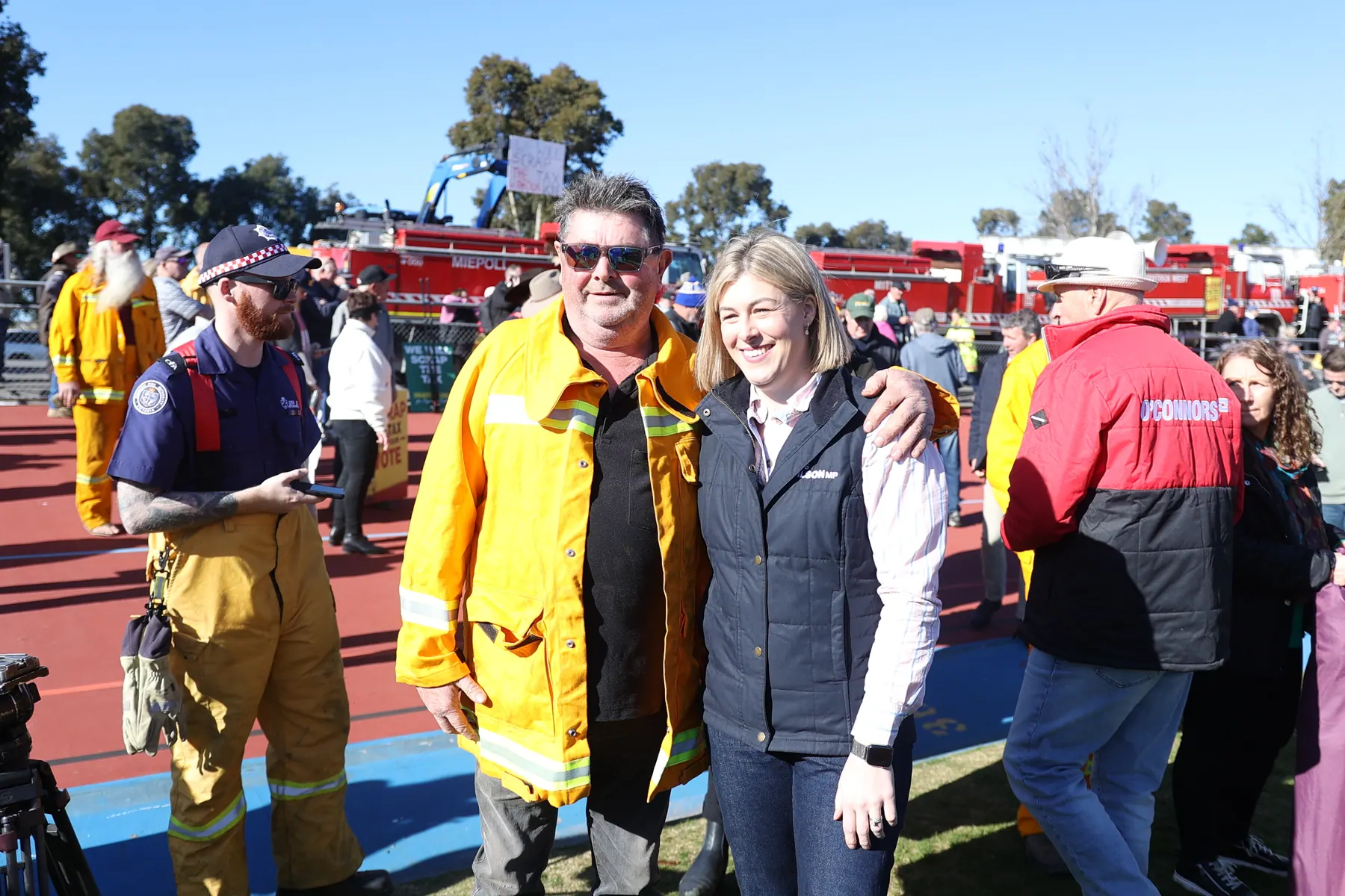 Jess Wilson stands with CFA volunteers at a rally against the Emergency Services Tax