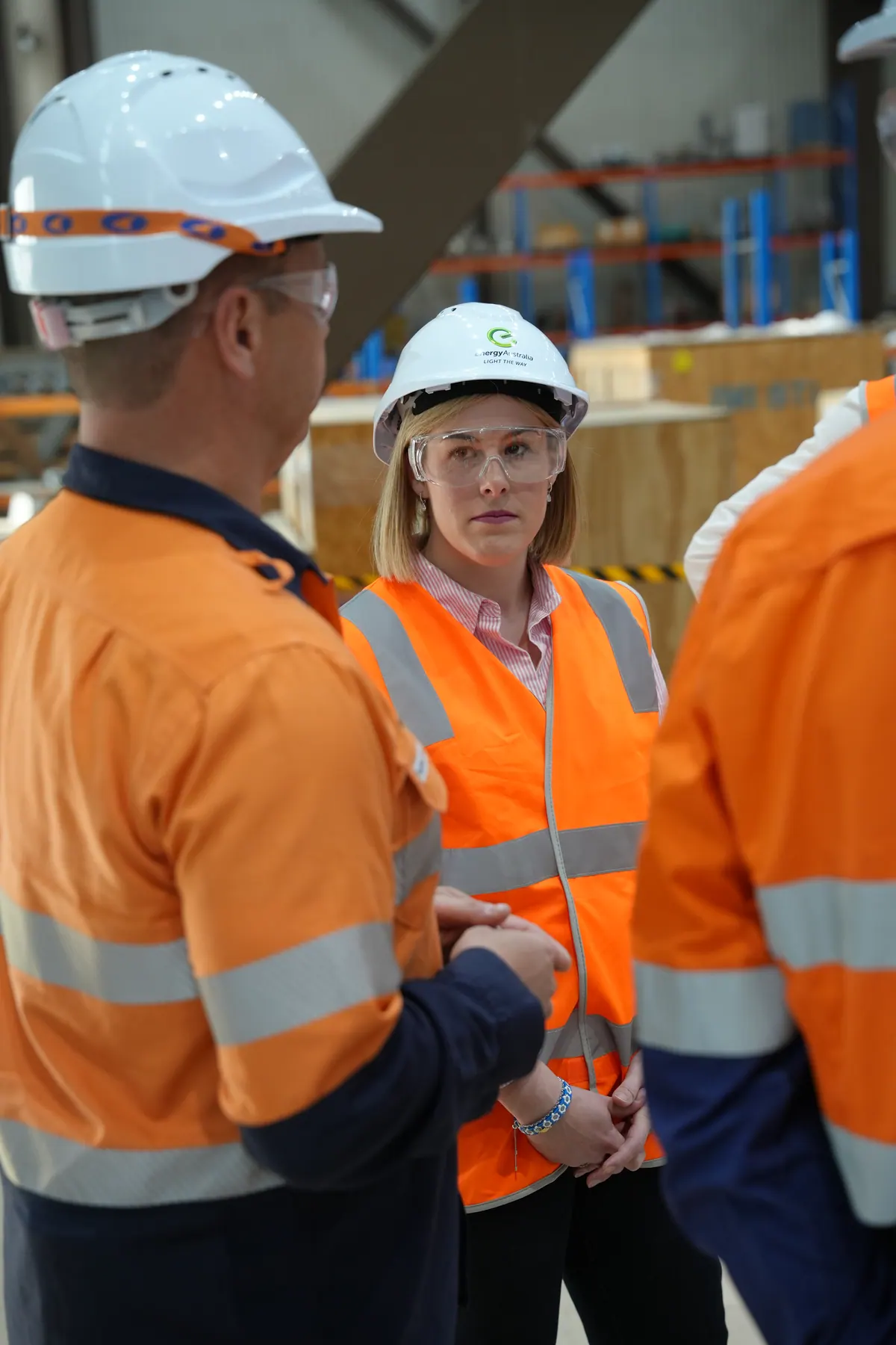 Jess Wilson in a hard hat and high-visibility jacket on a worksite