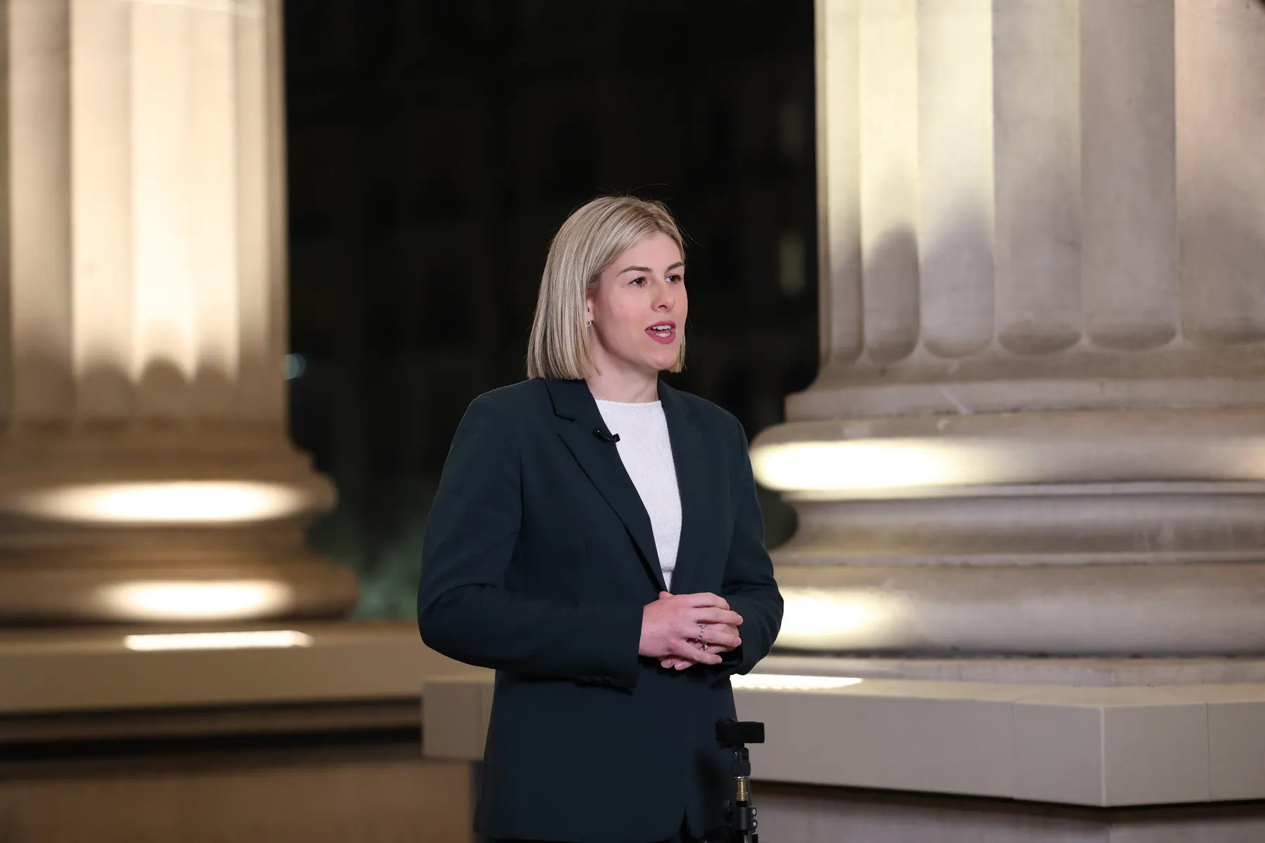 Jess Wilson speaks to media on the steps of Parliament House at night