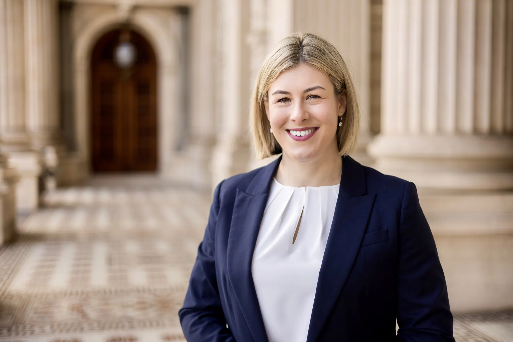 Jess Wilson smiling in the corridors of Parliament House, Melbourne